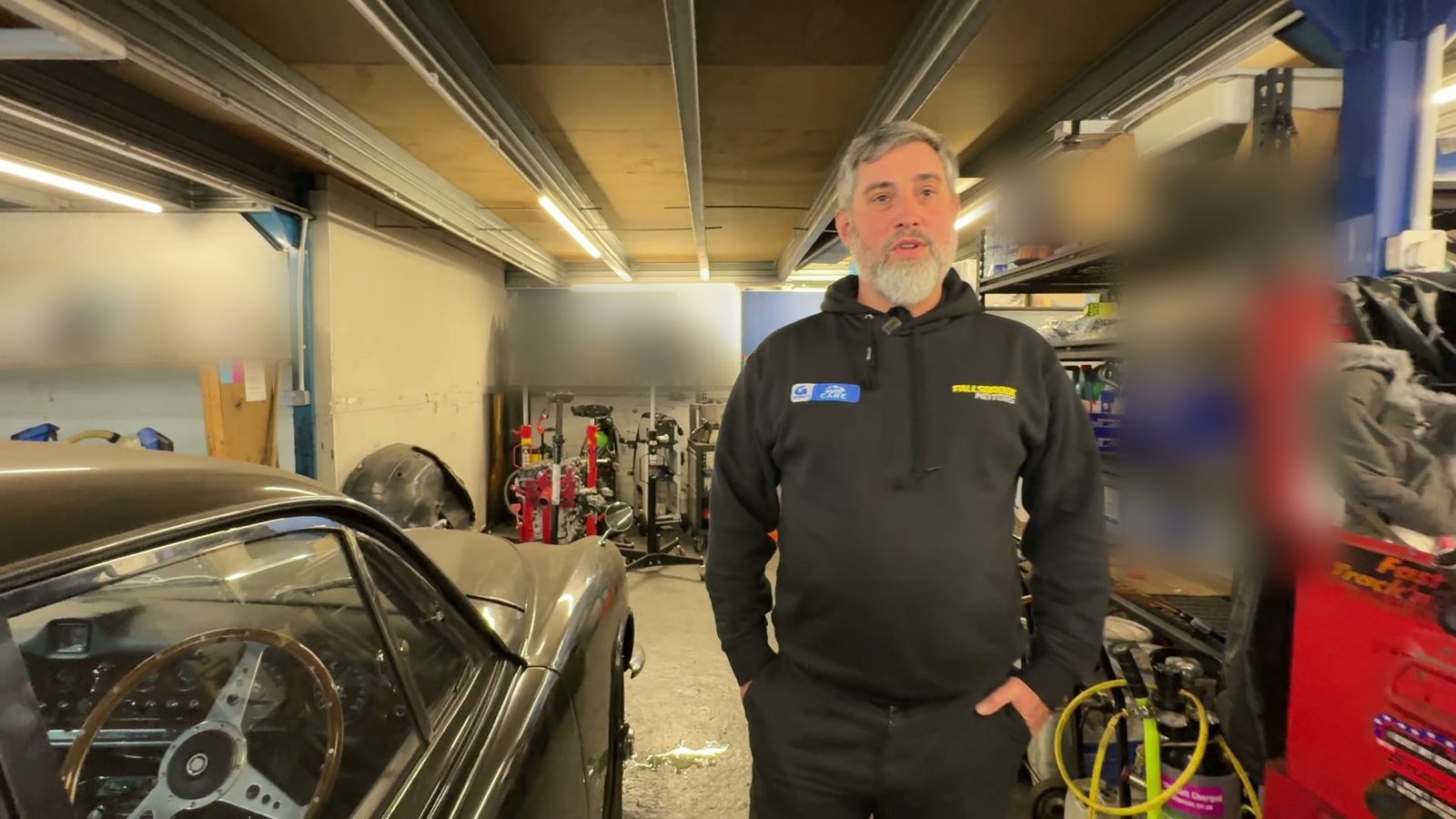 Simon beside his 1968 Jaguar 420 in the workshop.