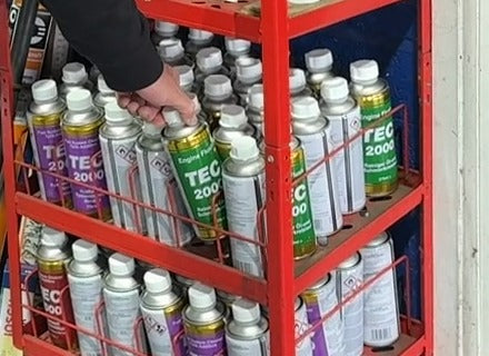 Still from the raw interview recording (IMG_4971, 189.9 s). As he says "Two of these", Simon takes hold of a can of TEC 2000 Engine Flush on the display rack.